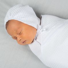 Handmade in the USA This timeless boys baby bonnet is the perfect finishing touch to his take home outfit. Made with our soft quilted cotton in white, it is trimmed in white linen so it matches his Elijah newborn gown or romper perfectly, yet is simply styled for any newborn outfit. White linen ties under the chin allow for a comfortable fit. An adorable traditional baby bonnet to keep your newborn baby boy warm and styled. 100% white quilted cotton White linen trim Sizing - Head up to 15" Inclu Baby Boy Bonnet, Fitted White Bonnet For Baptism, White Fitted Bonnet For Baptism, White Cotton Bonnet For Baptism, Boy Bonnet, Newborn Baby Bonnet, Homecoming Outfit, Newborn Bonnet, Newborn Gown