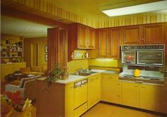 a kitchen with wooden cabinets and yellow appliances in the center is an open floor plan