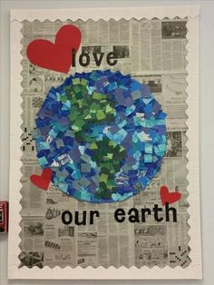 a piece of paper with the words love our earth on it and hearts cut out of newspaper