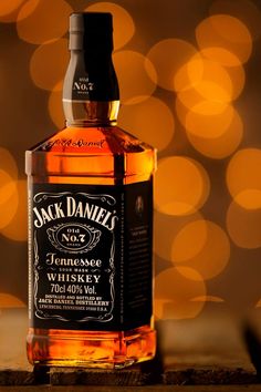 a bottle of jack daniels whiskey sitting on top of a table