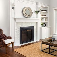 a living room with white walls and a fireplace