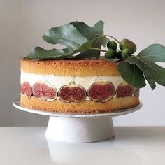 a cake decorated with figs and leaves