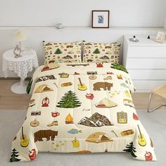 the bed is covered with many different types of things on it, including trees and mountains