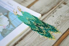 Extra long beaded fringe earrings, Turquoise emerald green gold tassel seed beaded earringsWhole length : 5.8" (14.5 cm)❤ CUSTOM ORDERSIt is ABSOLUTELY HANDMADE . So if you like this item in a different color or size, send me a message please. I will send you a link for a "custom order" and you'll be able to place the order there. Please feel free to communicate with me.SHIPPINGItem will be shipped carefully packed in a GIFT BAG!! Shipping cost includes tracking number!-If item is ready to ship Animal Print Jewelry, Seed Beaded Earrings, Celebrities Earrings, Beaded Fringe Earrings, Bottle Earrings, Beaded Tassel Earrings, Beaded Rope, Printed Jewelry, Earrings Turquoise