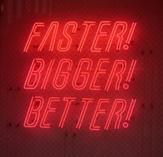 a red neon sign that says faster bigger better