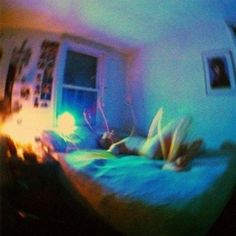 a blurry image of a person laying on a bed in a room with a window