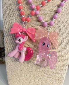 two little pony necklaces on a mannequin