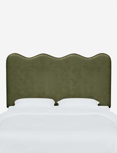 an upholstered headboard on a bed with white sheets and pillows, against a plain background