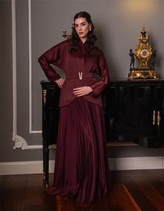 Indulge in timeless elegance with this stunning burgundy dress that features a unique jacket detail and a flowing pleated skirt. The dress is designed for women who appreciate a blend of classic and modern styles. The chic jacket, complete with a stylish belt, adds structure and sophistication to the ensemble, while the pleated skirt flows gracefully with every step. Ideal for formal occasions such as weddings, galas, or evening events, this dress offers a perfect combination of luxury and comfo Dress With Pleated Skirt, Indian Women Fashion, Chic Jacket, Burgundy Jacket, Casual Indian Fashion, Unique Jackets, Rich Burgundy, Burgundy Dress, Burgundy Color