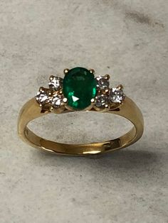 14kt Yellow Gold Lady's Diamond and Emerald Ring consisting of 1- 7mm x 5mm Genuine Oval Emerald Gemstone 3/4ct approx. total weight with 6 full cut round brilliant diamonds .30ct total weight SI1 clarity, G color all prong set in solid setting in finger size 6 3/4. This classic style ring can be resized for an additional $95.00 upon request. Emerald is the birthstone for May. This item would Retail for $3,145.00 Classic Diamond Cluster Ring For May Birthstone, Classic Diamond Ring With Vvs Clarity For May Birthstone, Classic Emerald Ring With Diamond And 14k Stamp, Classic Emerald Ring With Diamond Stamped 14k, Round 14k Diamond Ring For May Birthstone, Diamond And Emerald Ring, Smaragd Ring, Dream Engagement, Dream Engagement Rings