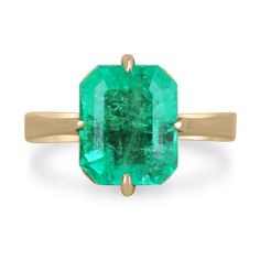 an emerald ring on a white background