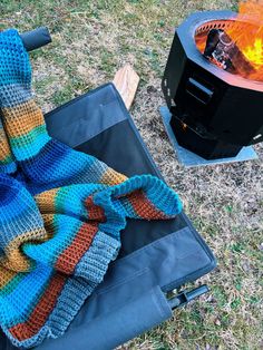 a blanket is laying on top of an open fire pit