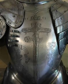 a metal armor with a cross on it