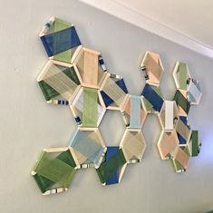 a wall sculpture made out of wood and colored glass tiles on the wall in an office