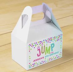 a white box with the word jump on it sitting on top of a wooden table