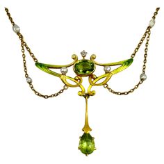 Beautiful Art Nouveau period 18K gold, Ombre enamel, faceted peridot, diamond and natural pearl necklace. With a central oval peridot measuring 9mm by 6mm, surrounded by fine stylized Art Nouveau undulating asymmetrical designs in ombre enamel colors ranging from moss green to pale apricot to lemon yellow, diamond and pearl accents, a long drop pendant with a pear shaped faceted peridot measuring 9mm by 6mm. Chain link swags with pearl centers join the body of the necklace, creating a classic Ar Edwardian Necklace, Design Art Nouveau, Festoon Necklace, Peridot Birthstone, Natural Pearl Necklace, Art Nouveau Pendant, Nouveau Jewelry, Gold Book, Edwardian Jewelry