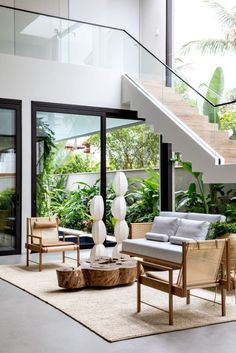 a living room filled with furniture and plants