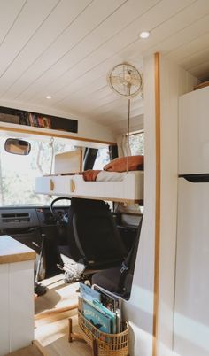 the interior of a camper with bunk beds and desks in it's center