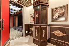 an ornately decorated hallway with red doors