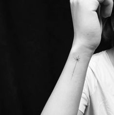 a woman with a small star tattoo on her arm