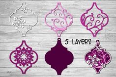 paper cutout christmas ornaments with the word 5 layers on it in purple and white