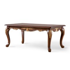 a wooden table with ornate carvings on the top and legs, against a white background