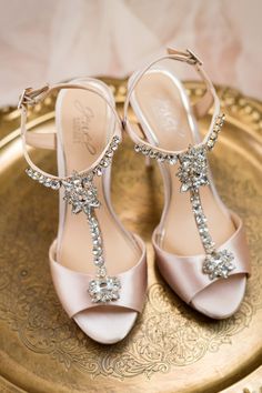 the bride's shoes are adorned with crystal stones