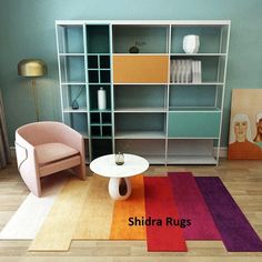 a living room filled with furniture and rugs on top of a hard wood floor