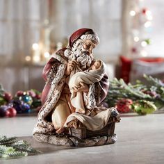 a figurine is sitting on the floor next to christmas decorations