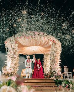 the newly married couple are walking down the aisle with confetti falling all around them