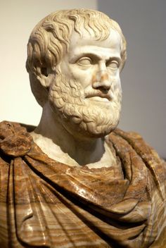 an ancient statue of a man with a beard