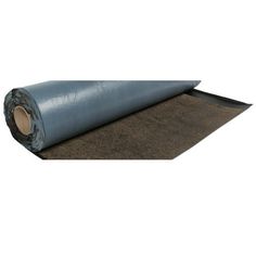 a roll of blue tarp sitting on top of a brown mat covered in sand