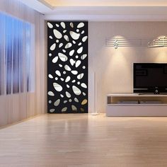 a modern living room with white walls and wood flooring, large screen tv on the wall