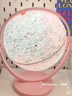 a pink and white globe with writing on it