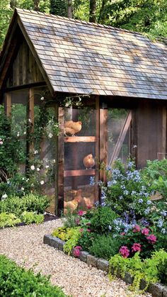 a garden shed with flowers and plants around it