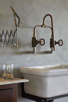 an old fashioned sink and faucet are hanging on the wall in a bathroom