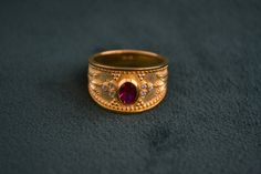 This byzantine ring is made with solid sterling silver (925 silver) that has 22k gold plating. It is enriched with an oval Cz Ruby in the middle, and 6 small White Cz around it. Byzantine Style Hallmarked Engraved Wedding Ring, Hallmarked 22k Gold Byzantine Rings, Gold Byzantine Ruby Ring For Gift, 14k Gold Byzantine Ring Gift, Byzantine Hallmarked Engraved Wedding Ring, Gold Byzantine Ruby Ring, Ceremonial Byzantine Ring, Luxury Gold Byzantine Ruby Ring, Byzantine Ring