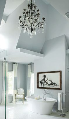 a bathroom with a chandelier and white bathtub