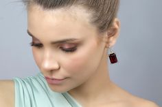 Make a statement with these gorgeous Rectangular Garnet Gold Dangle Earrings. Measuring 13x18mm, these earrings feature prong-set semiprecious garnet stones, making them a perfect accessory to celebrate your January birthstone. The gold finish adds a touch of luxury, making these earrings a great choice for special occasions. These handmade earrings are crafted with high-quality materials and are sure to last for years to come. January birthstone garnet earrings Prong set semiprecious stones Han Elegant Earrings With Rectangular Stone For Anniversary, Classic Rectangular Stone Earrings, Elegant Anniversary Earrings With Rectangular Stone, Elegant Rectangular Stone Earrings, Elegant Jewelry With Rectangular Stone, Classic Formal Earrings With Rectangular Stone, Elegant Garnet Earrings, Elegant Jewelry With Rectangular Stone For Formal Occasions, Elegant Formal Jewelry With Rectangular Stone