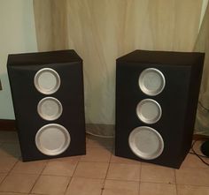 two speakers sitting side by side on the floor