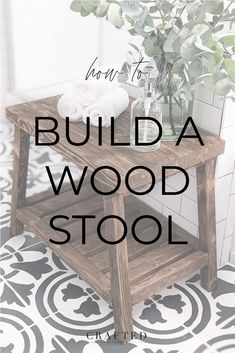 a wooden stool sitting on top of a tiled floor next to a potted plant