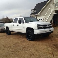 a white truck parked in front of a house