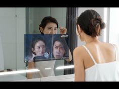 a woman looking at herself in the mirror