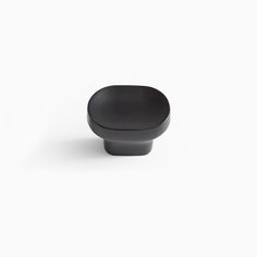 a black cabinet knob on a white background