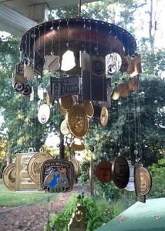 a wind chime hanging from the side of a building with lots of coins attached to it