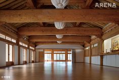 an empty room with wooden walls and ceiling beams is seen in this image from the inside