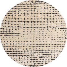 a round rug with black and white designs on it, in the shape of a circle