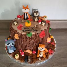 a birthday cake with woodland animals on it