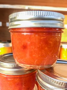 several jars filled with jam sitting on top of each other