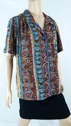 "80's Women's Shirt Short Sleeve Blue Brown Gold Turquoise Cool Geo Abstract Print Button Down Like New Vintage by HILL ARCHER Size XL Super cute fun summer vacation! Button down, black buttons, short sleeve, tiny collar, gather across shoulder, drapy silky light weight fabric, colorful. Blue brown gold pink gold geo colorblock abstract print. Excellent Condition. Easy to wear casual chic vintage for the disco sporting life. MEASUREMENTS: Length - 27\" Bust (underarms to underarms) - 23\"x 2 Sle Blue Retro Print Button-up Top, Blue Retro Tops With Buttons, Blue Vintage Blouse With Relaxed Fit, Retro Blue Collared Blouse, Retro Blue Blouse With Buttons, Blue Retro Blouse With Buttons, 80s Shorts, Hawaiian Shirt Women, Women Shirt Top